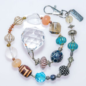 Suncatcher with assorted patterned beads and a faith label